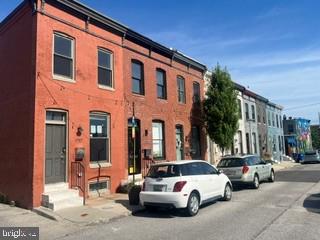 917 North Port Street Baltimore, MD 21205 - Photo 2 of 14 a view of a cars park in front of a building