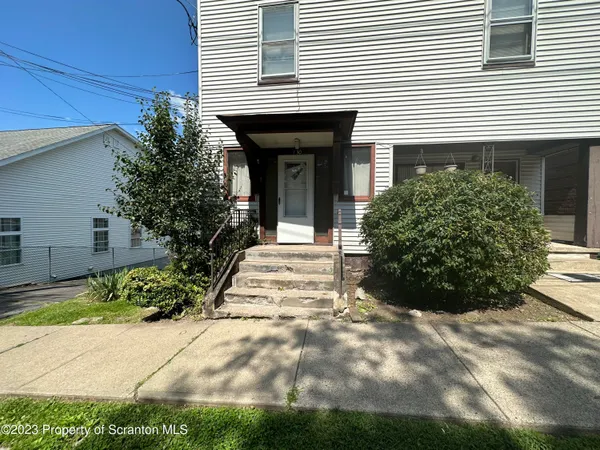 a view of a house with a yard and plants
