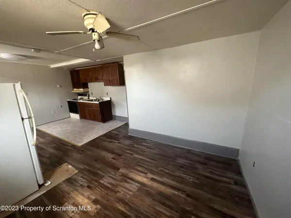 a view of a room with wooden floor and window
