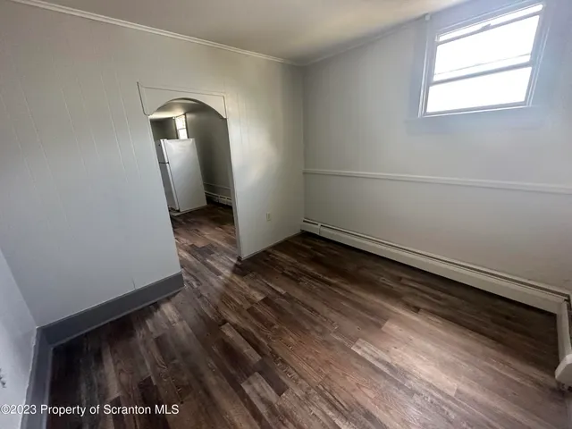 a view of room with window and hardwood floor