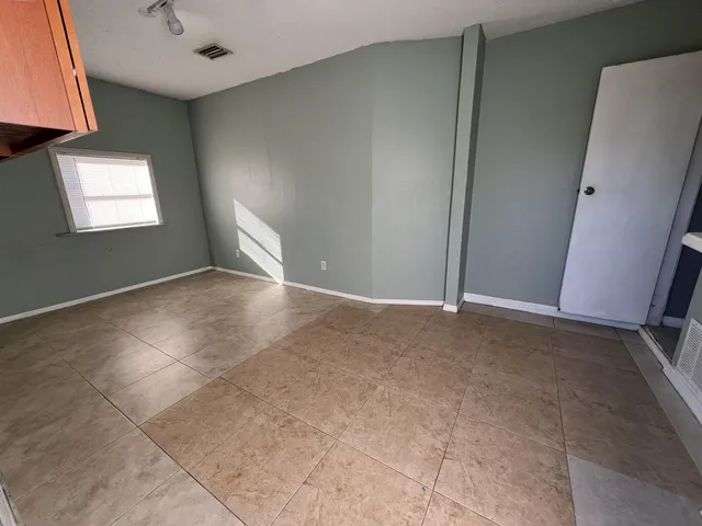 an empty room with windows and closet