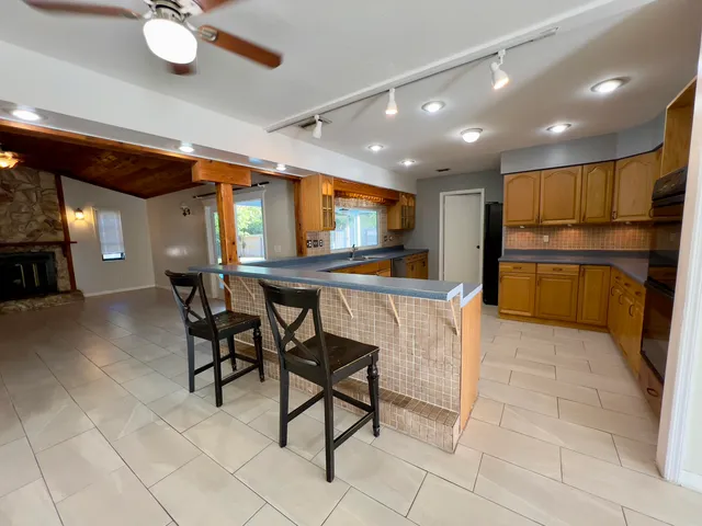 a view of kitchen with furniture and a refrigerator