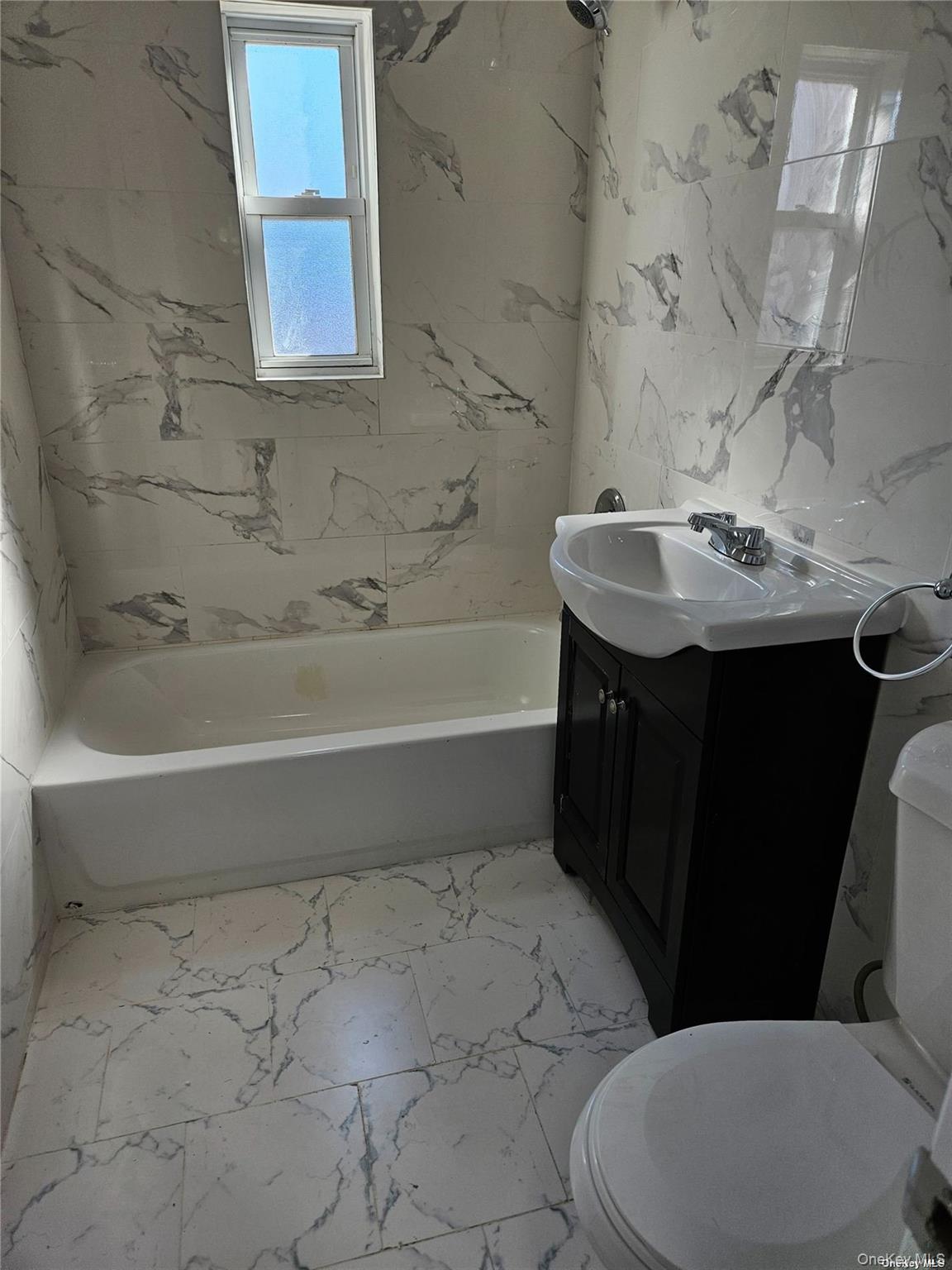 1918 Hunt Avenue Bronx, NY 10462 - Photo 12 of 15 a bathroom with a sink a toilet and bathtub