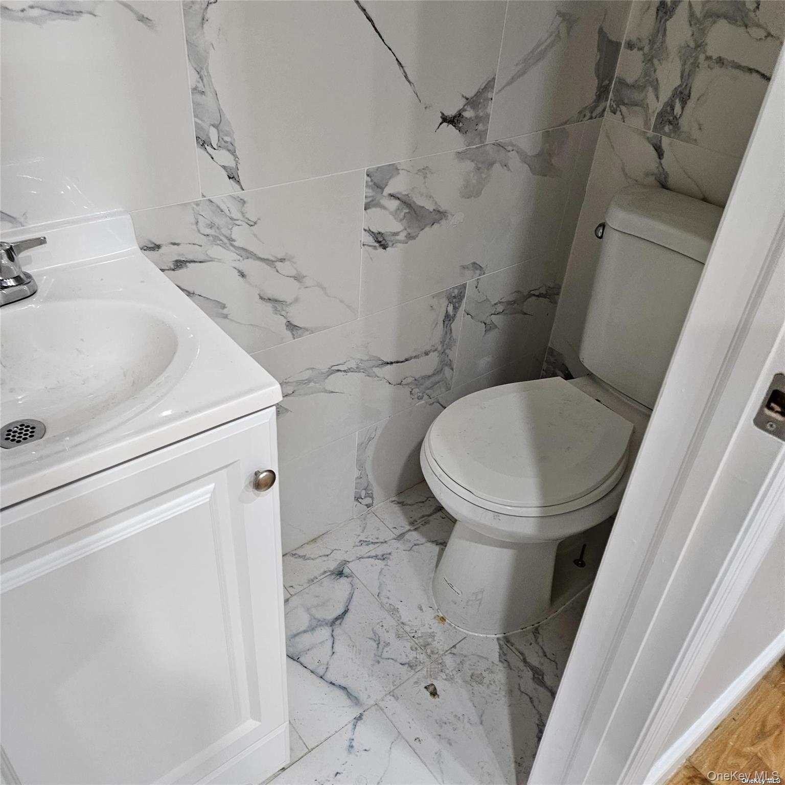 1918 Hunt Avenue Bronx, NY 10462 - Photo 8 of 15 a white toilet sitting next to a sink and vanity