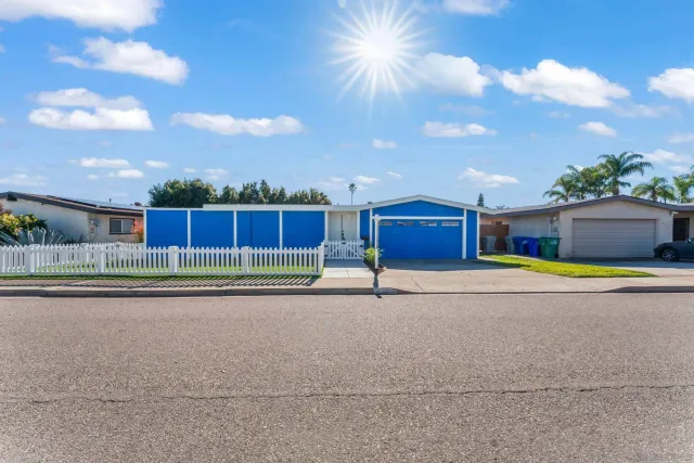 a kitchen with stainless steel appliances granite countertop a refrigerator a stove and a sink