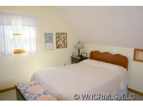 28 Hampton Road Leicester, NC 28748 - Photo 11 of 22 a bedroom with a bed and a wall painting