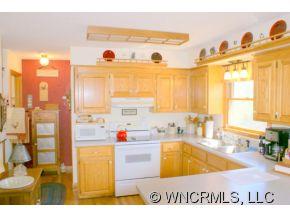 28 Hampton Road Leicester, NC 28748 - Photo 6 of 22 a view of a kitchen with kitchen island a large window and a sink