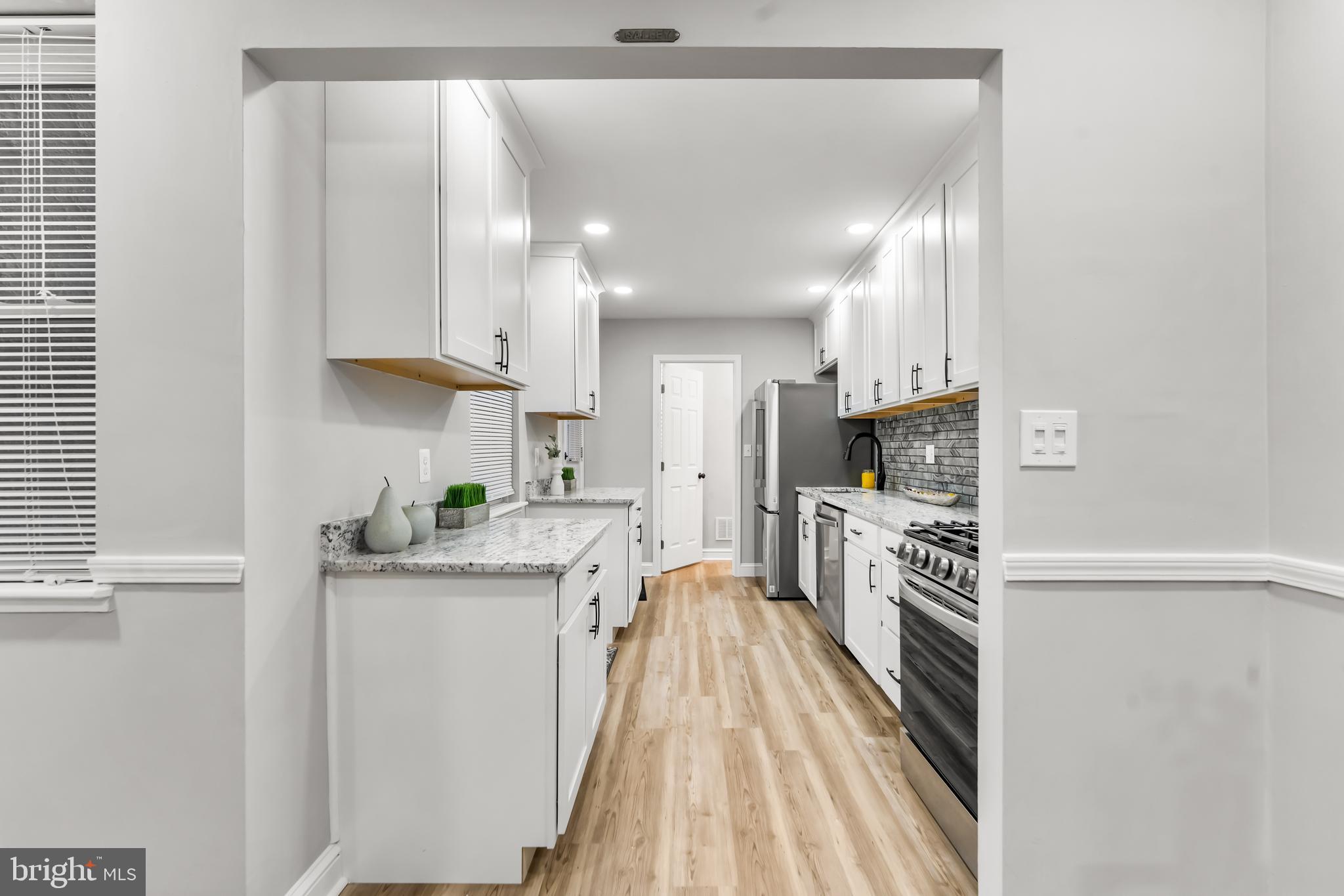 1261 Riverside Avenue Baltimore, MD 21230 - Photo 12 of 60 a kitchen with stainless steel appliances a sink stove and refrigerator