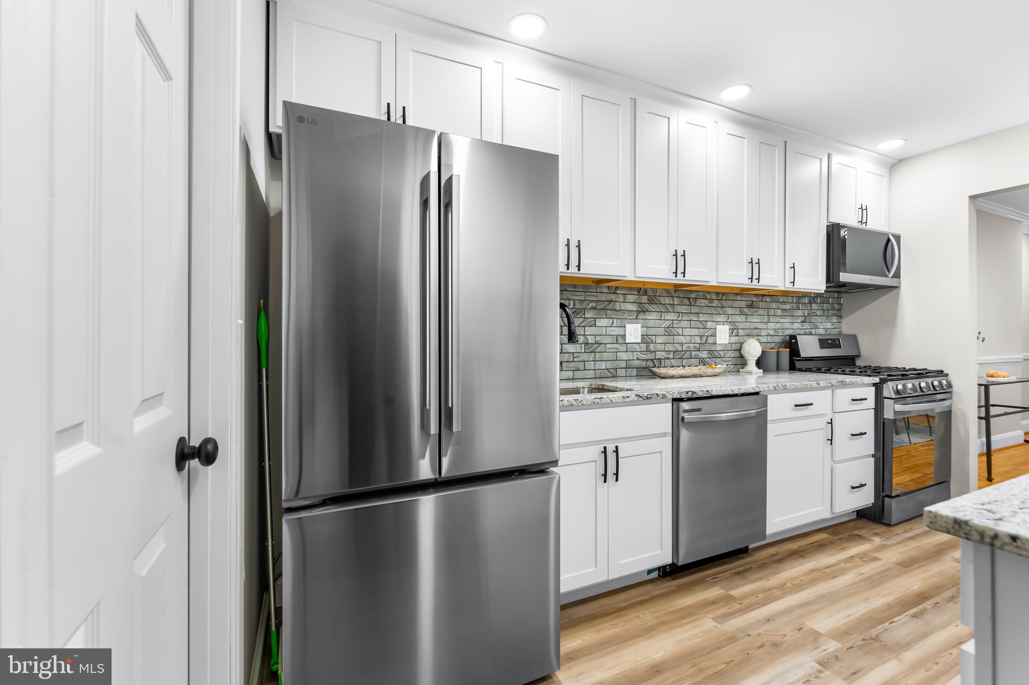 1261 Riverside Avenue Baltimore, MD 21230 - Photo 13 of 60 a kitchen with stainless steel appliances a refrigerator a stove a sink and a refrigerator
