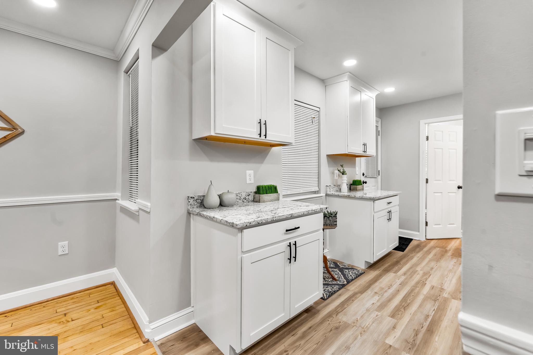 1261 Riverside Avenue Baltimore, MD 21230 - Photo 14 of 60 a kitchen with granite countertop white cabinets and white appliances