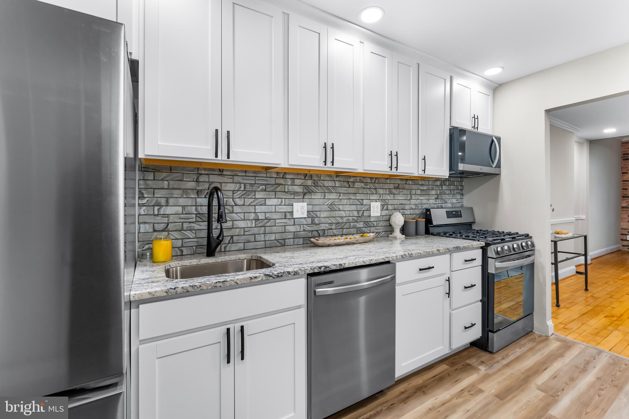 1261 Riverside Avenue Baltimore, MD 21230 - Photo 15 of 60 a kitchen with stainless steel appliances granite countertop a sink stove and cabinets