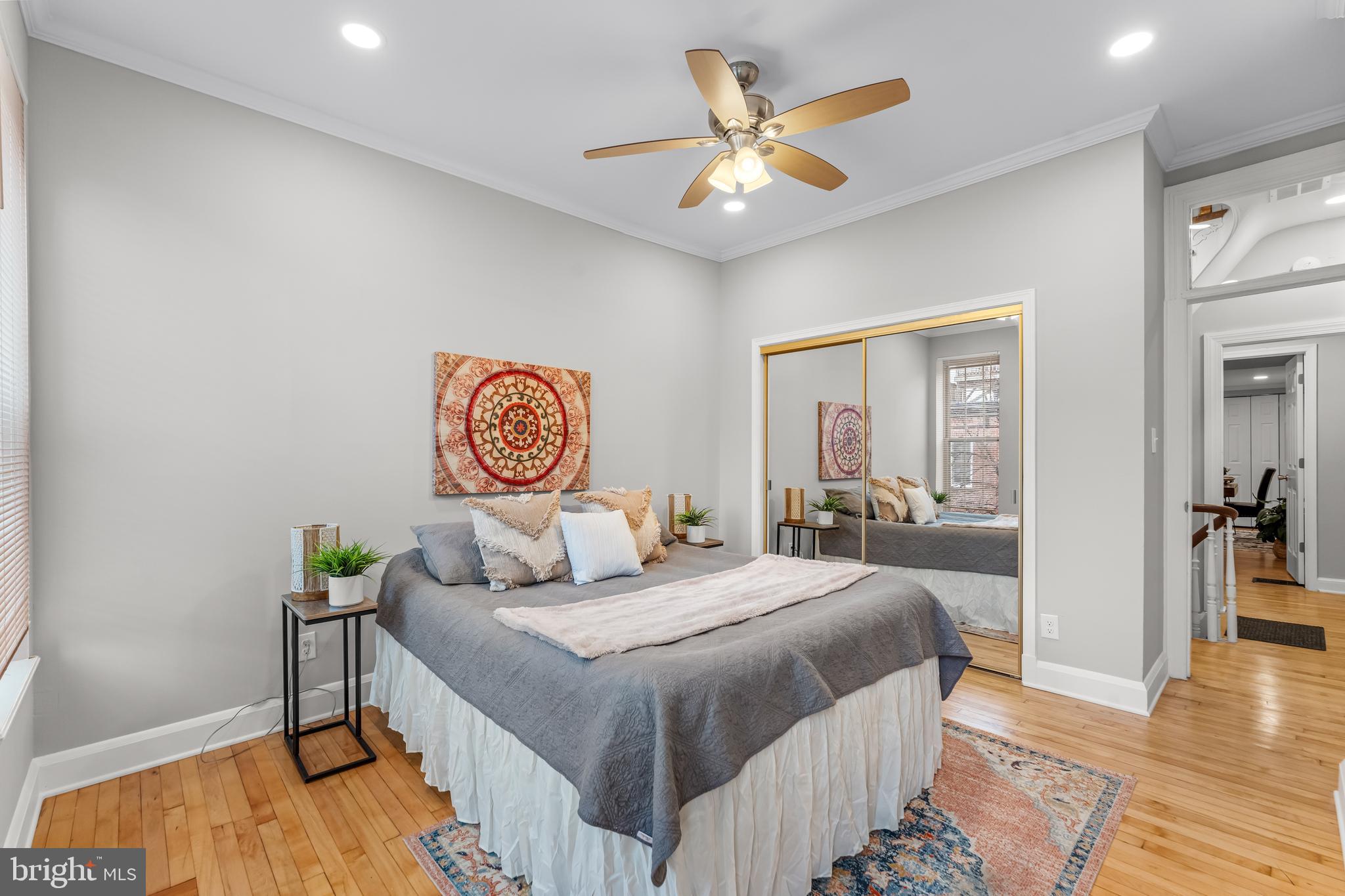 1261 Riverside Avenue Baltimore, MD 21230 - Photo 18 of 60 a bedroom with a bed and wooden floor