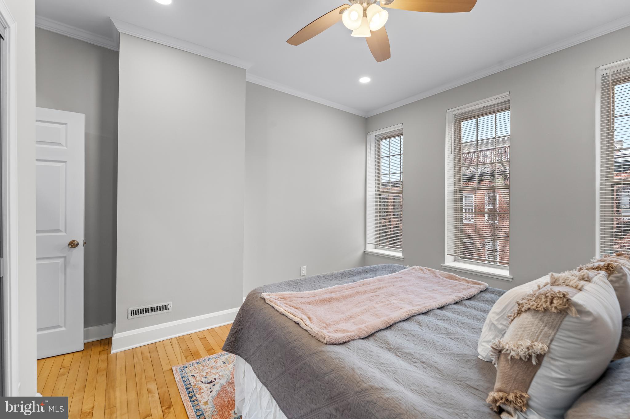 1261 Riverside Avenue Baltimore, MD 21230 - Photo 19 of 60 a bedroom with a bed and a chandelier