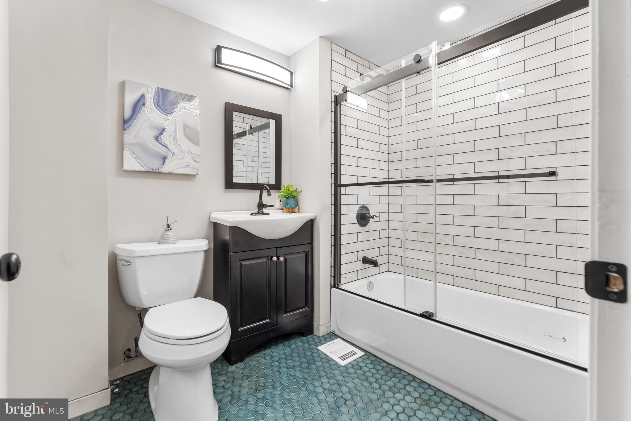 1261 Riverside Avenue Baltimore, MD 21230 - Photo 23 of 60 a bathroom with a sink a toilet and shower