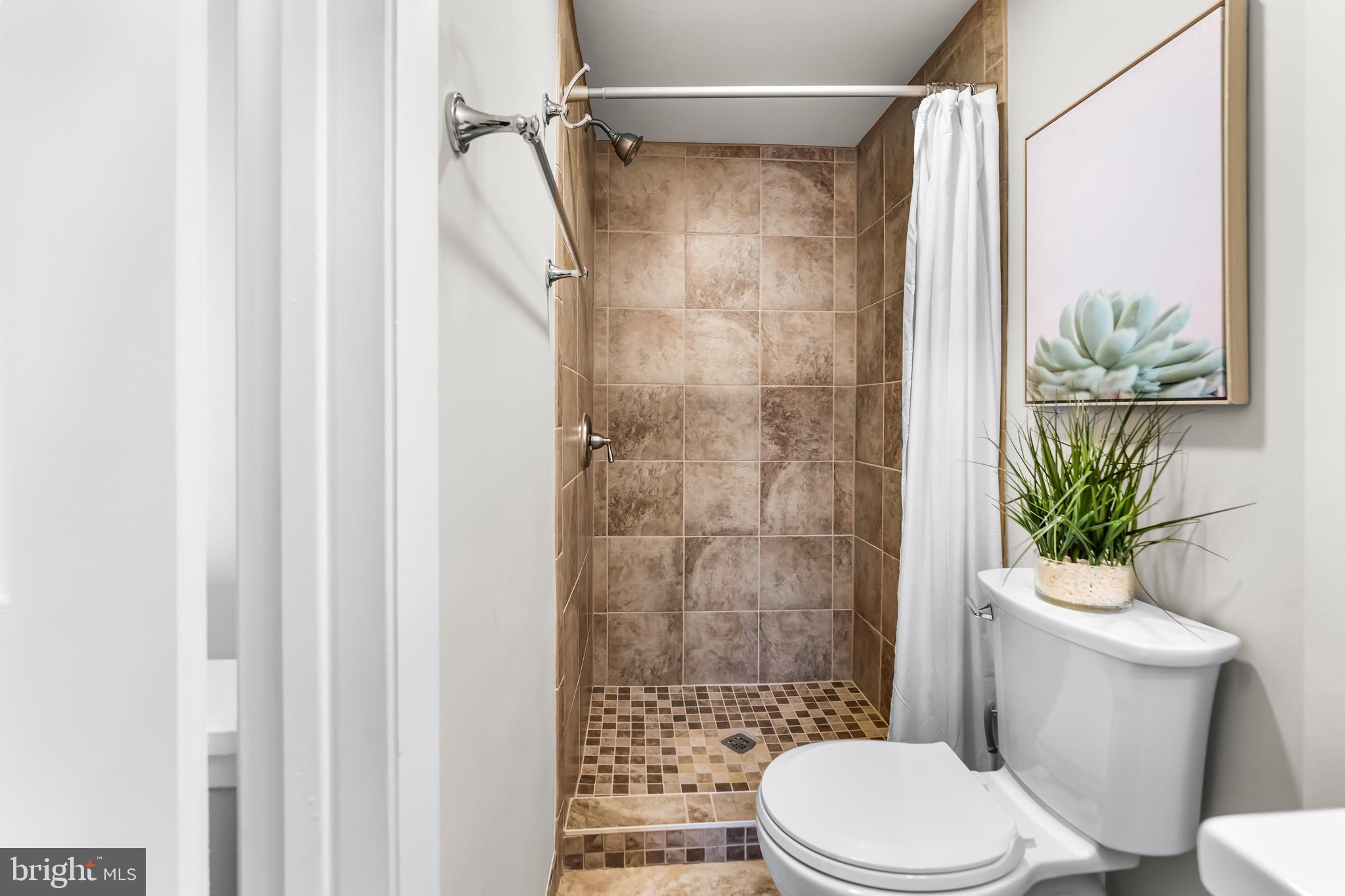 1261 Riverside Avenue Baltimore, MD 21230 - Photo 30 of 60 a white toilet sitting next to a bathroom sink