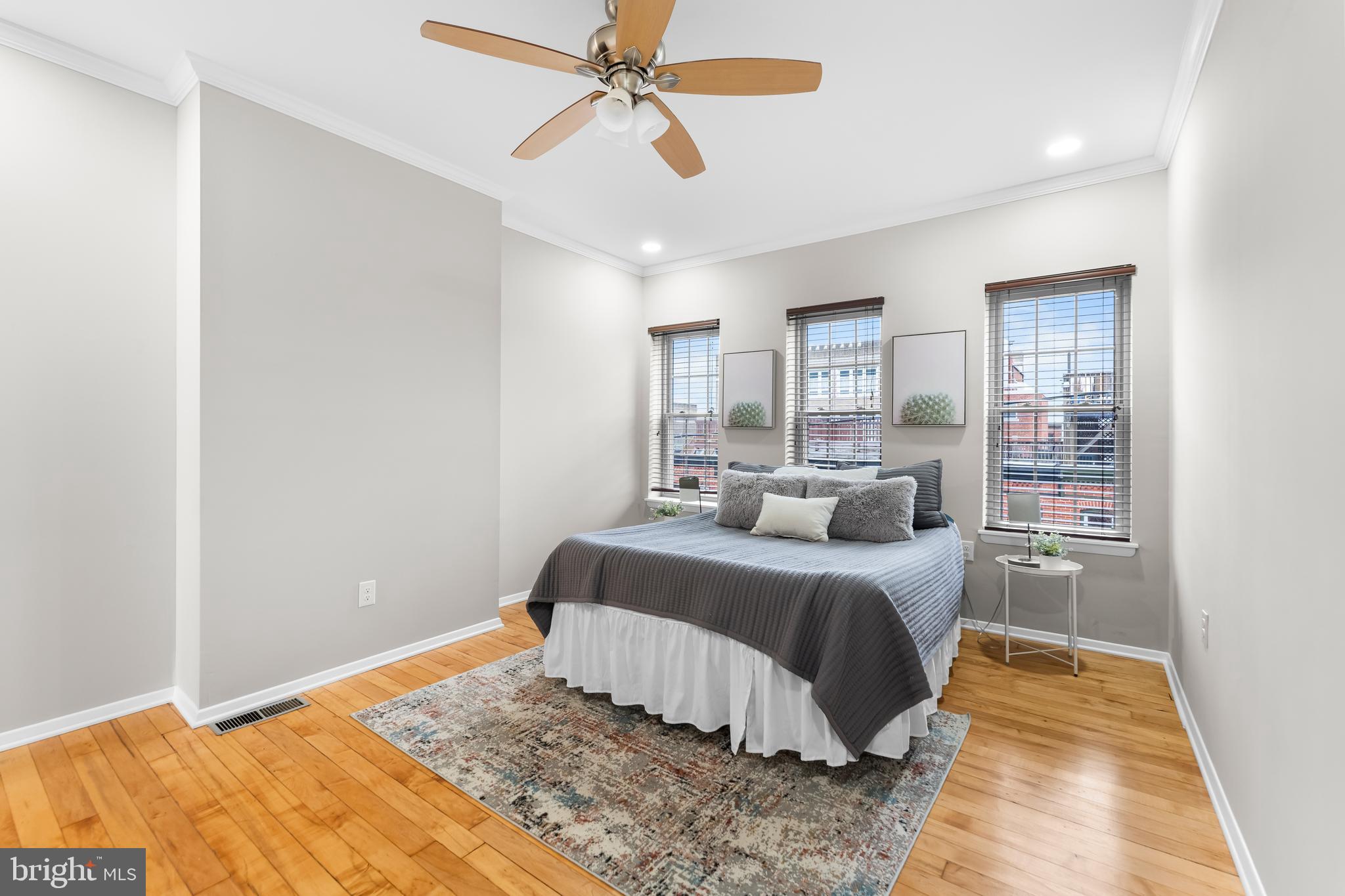 1261 Riverside Avenue Baltimore, MD 21230 - Photo 31 of 60 a bedroom with a large bed and wooden floor