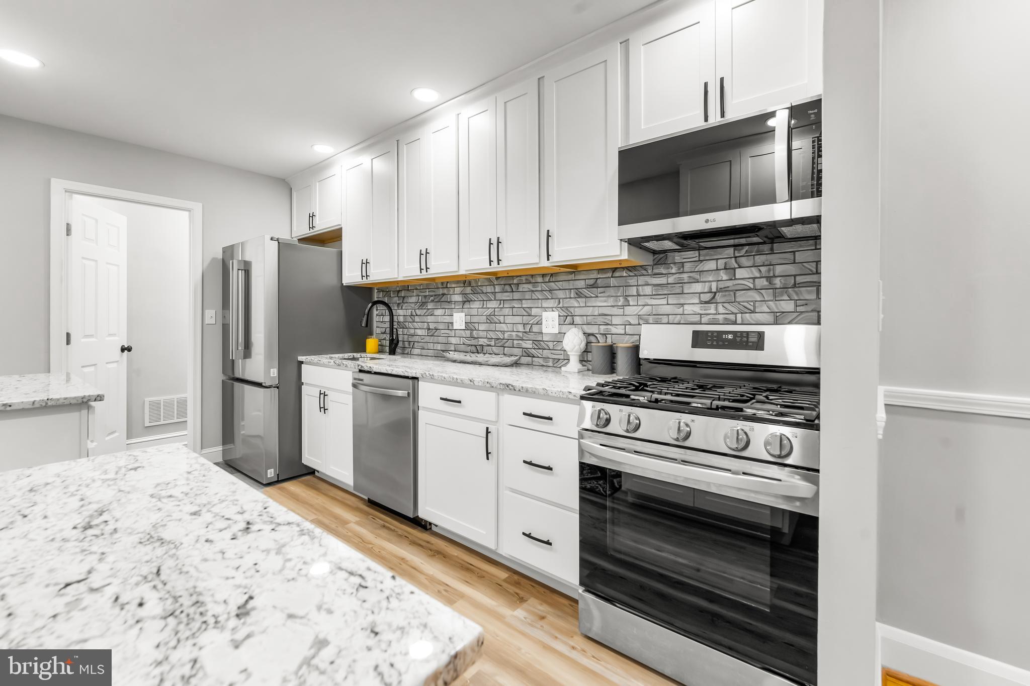 1261 Riverside Avenue Baltimore, MD 21230 - Photo 10 of 60 a kitchen with stainless steel appliances a stove a microwave and cabinets