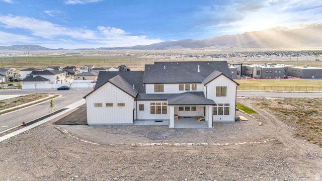 2828 Jojo Road Eagle Mountain, UT 84005 - Photo 62 of 63 Modern farmhouse exterior featuring white vertical siding and dark-trimmed windows