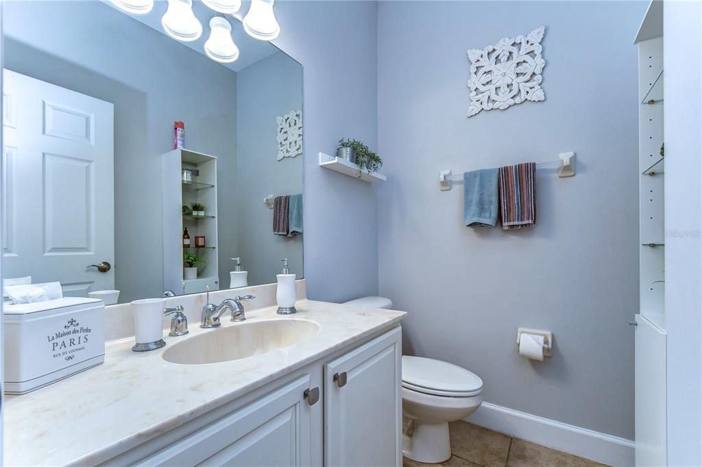 8507 Sandpiper Ridge Avenue Tampa, FL 33647 - Photo 19 of 48 a bathroom with a toilet sink and mirror