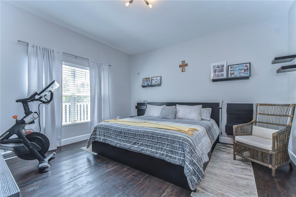 8507 Sandpiper Ridge Avenue Tampa, FL 33647 - Photo 32 of 48 a bedroom with a bed a couch and large window