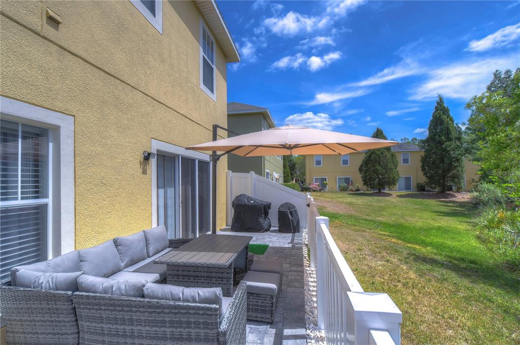 8507 Sandpiper Ridge Avenue Tampa, FL 33647 - Photo 37 of 48 a backyard of a house with table and chairs