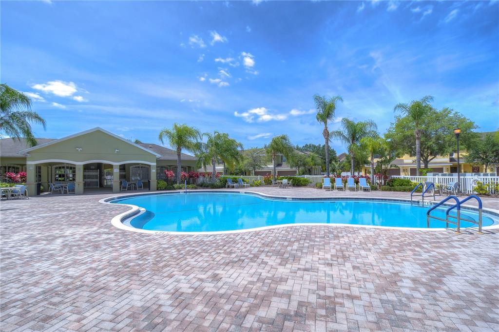 8507 Sandpiper Ridge Avenue Tampa, FL 33647 - Photo 45 of 48 a view of swimming pool with seating area and trees in the background