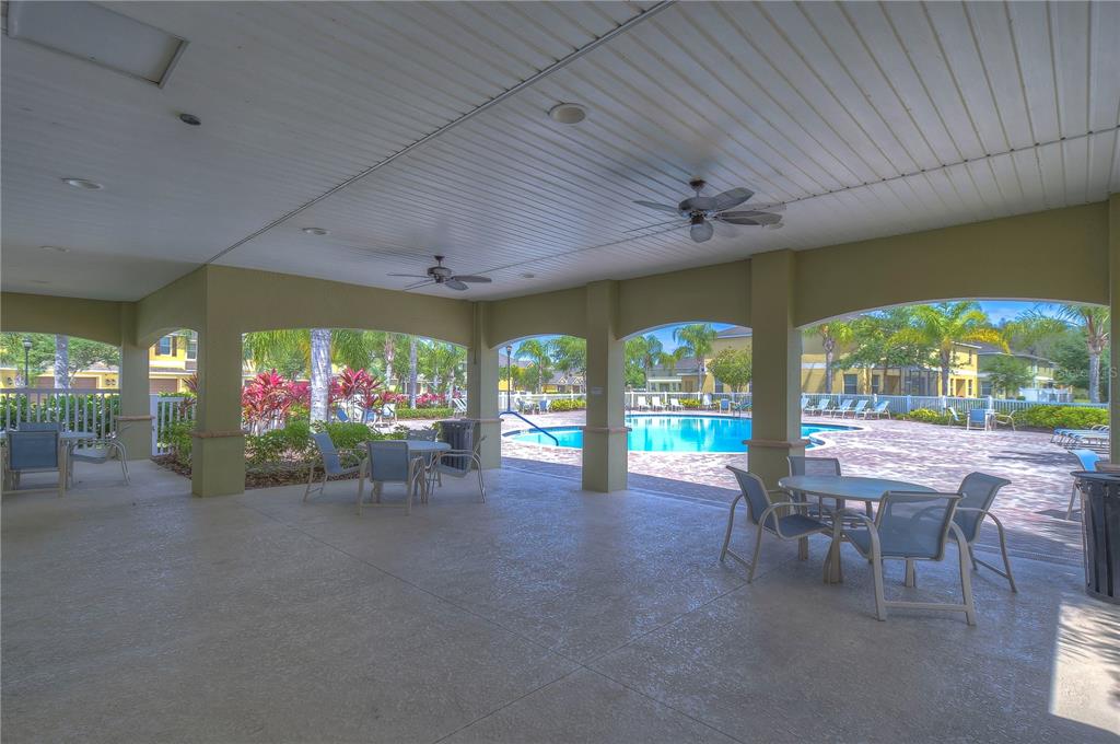 8507 Sandpiper Ridge Avenue Tampa, FL 33647 - Photo 47 of 48 a view of a patio with a table and chairs under an umbrella
