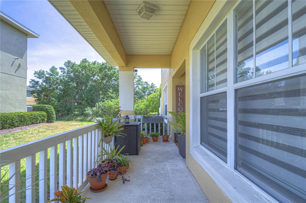 8507 Sandpiper Ridge Avenue Tampa, FL 33647 - Photo 5 of 48 a view of a porch with wooden floor and outdoor space