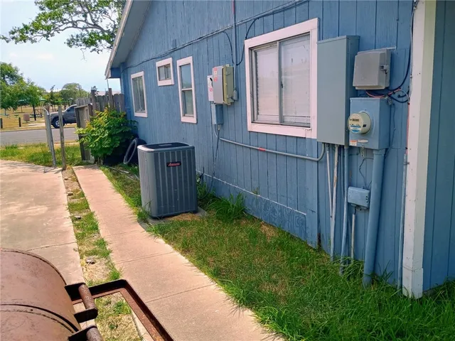 a view of backyard with barbeque grill and wooden fence