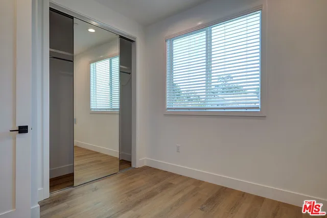 a bathroom with a double vanity sink a toilet and shower