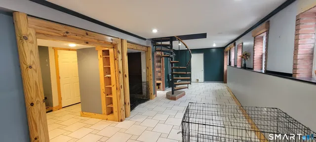 a view of a hallway with wooden shelves