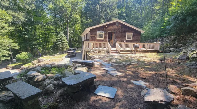 a front view of a house with a yard garage and outdoor seating