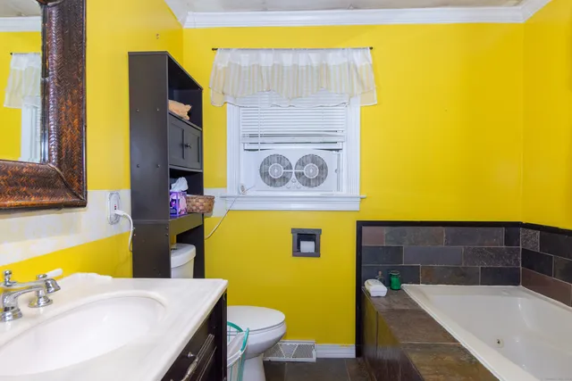 a bathroom with a sink mirror and bathtub