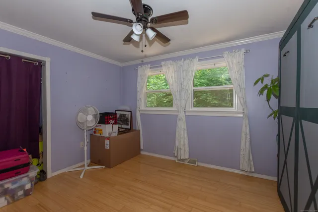 a view of livingroom with hardwood floor and a ceiling fan