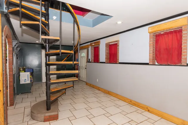 a view of an entryway with wooden floor