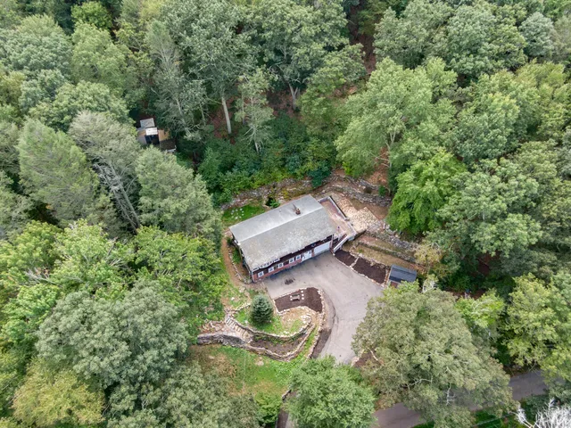 an aerial view of a house with outdoor space and street view