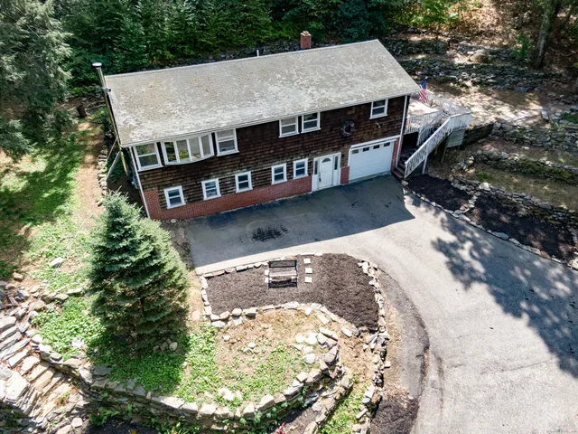 an aerial view of a house with a yard balcony