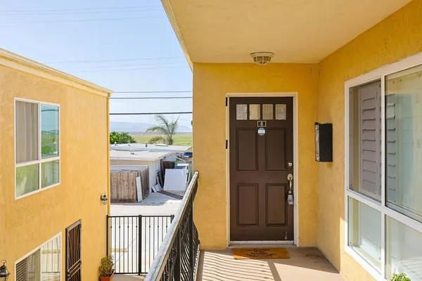 a porch with a table and chairs