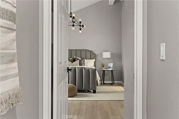 a view of a hallway with a room and chandelier