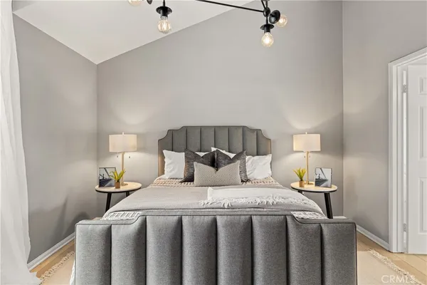 a bedroom with a bed and a night stand