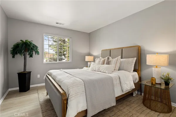 a bedroom with a bed and a window