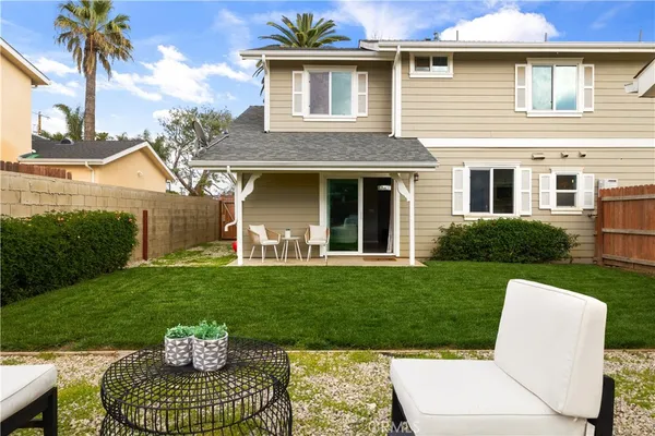 a view of a house with backyard sitting area and garden