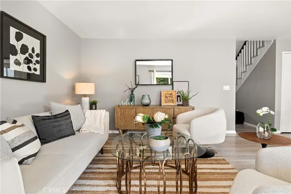 a living room with furniture and wooden floor