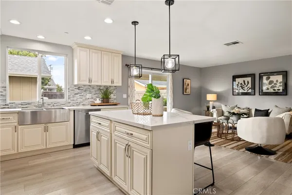 a kitchen with a table chairs sink and cabinets