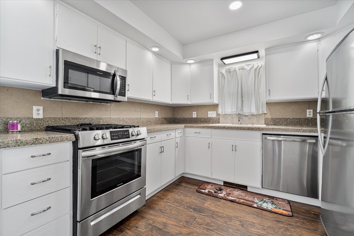 396 North Sherman Street El Paso, IL 61738 - Photo 11 of 29 a kitchen with granite countertop white cabinets white stainless steel appliances and a sink