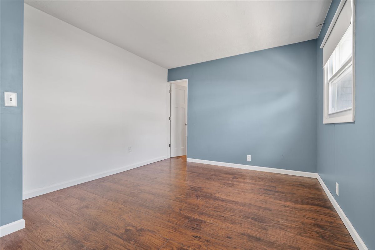 396 North Sherman Street El Paso, IL 61738 - Photo 14 of 29 a view of an empty room with wooden floor and a window