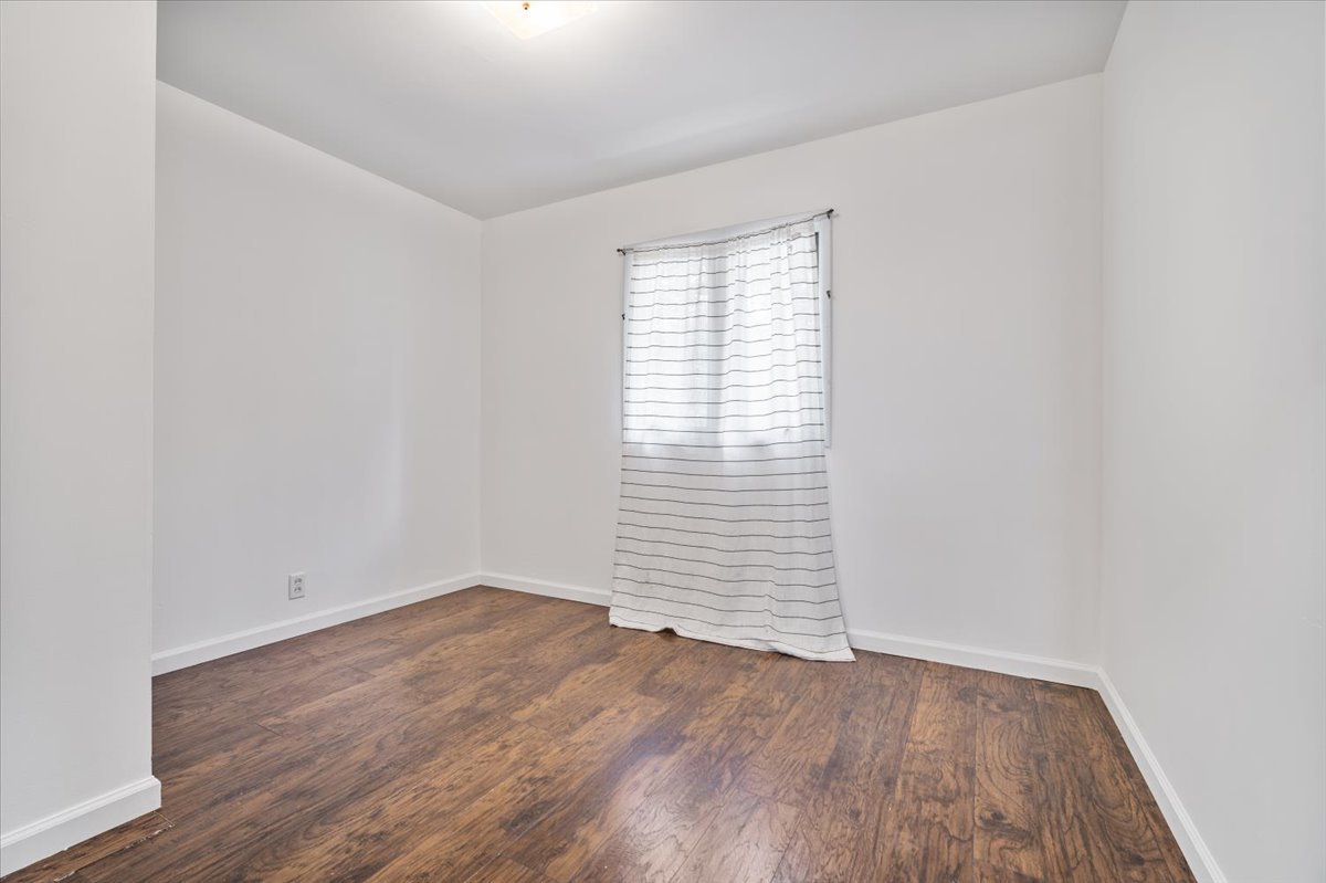 396 North Sherman Street El Paso, IL 61738 - Photo 18 of 29 an empty room with wooden floor and windows