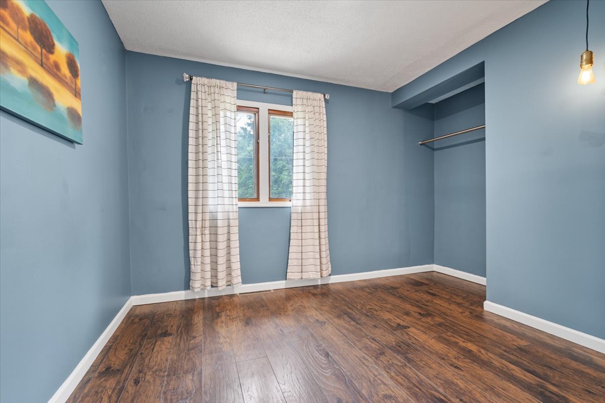396 North Sherman Street El Paso, IL 61738 - Photo 19 of 29 a view of an empty room with wooden floor and a window