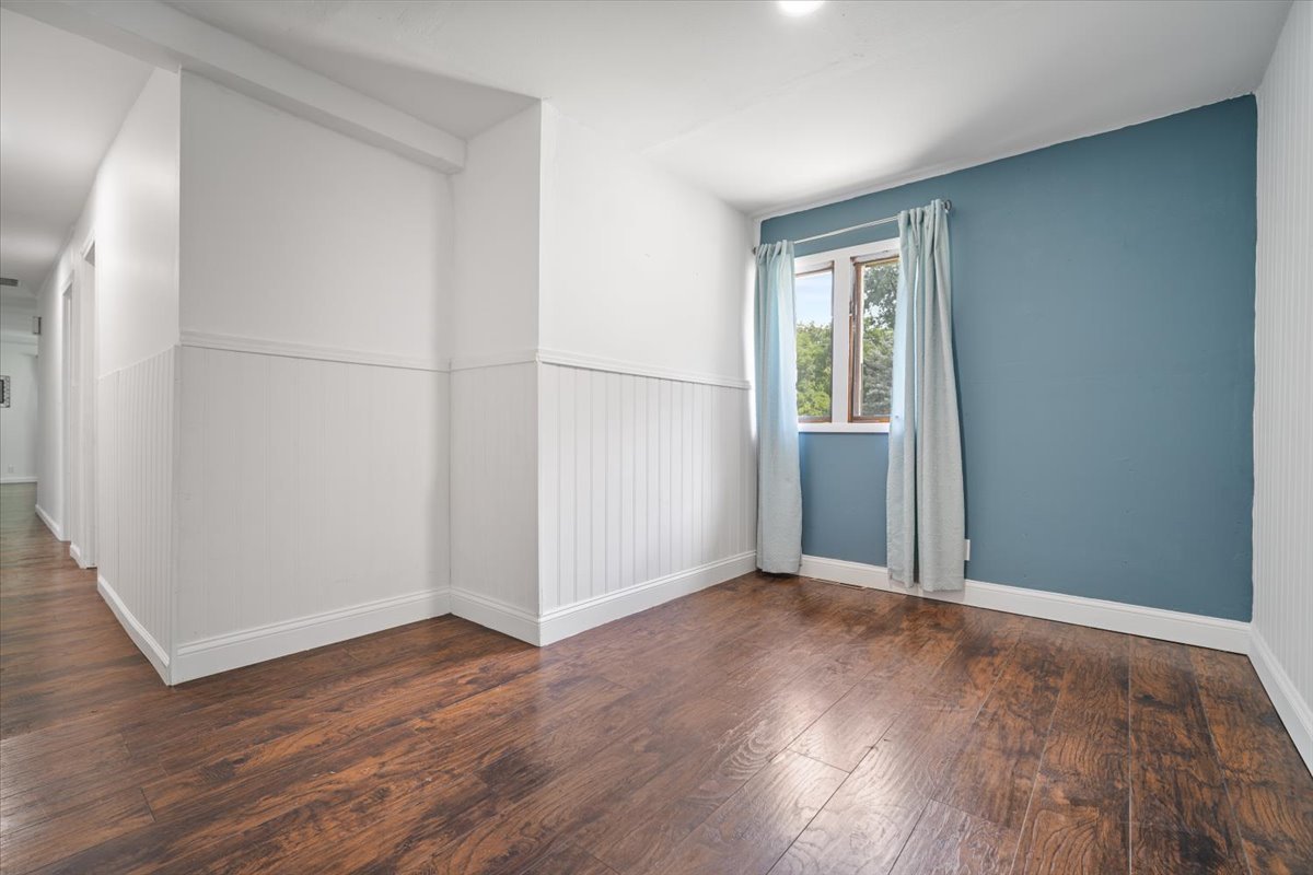 396 North Sherman Street El Paso, IL 61738 - Photo 22 of 29 an empty room with wooden floor and windows