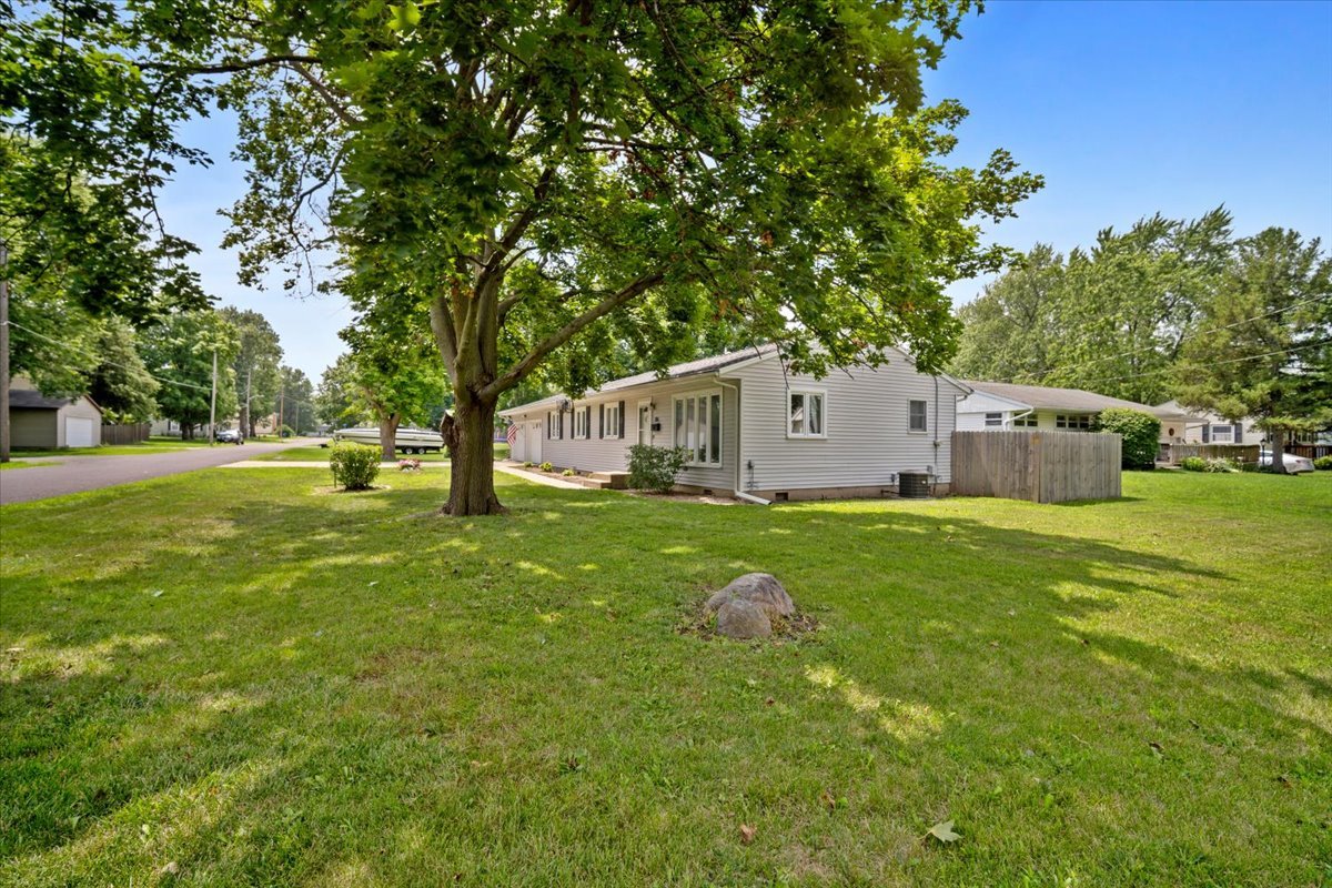 396 North Sherman Street El Paso, IL 61738 - Photo 26 of 29 a view of a white house with a big yard and large trees